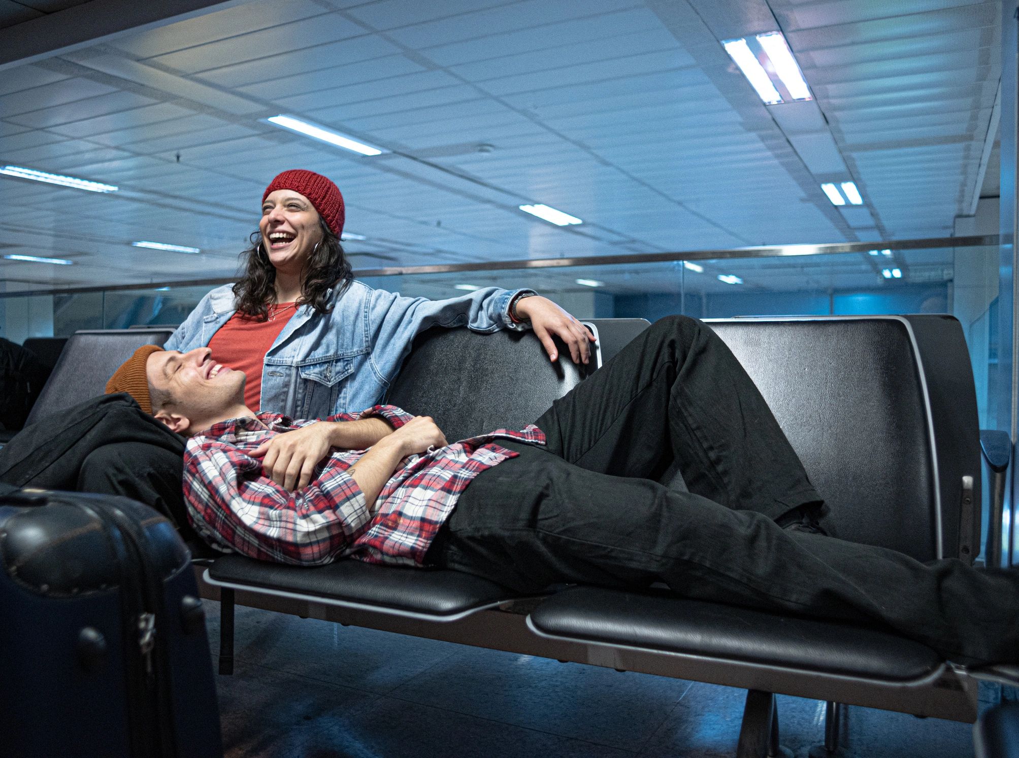 Couple relaxing in an airport lounge before a premium travel experience